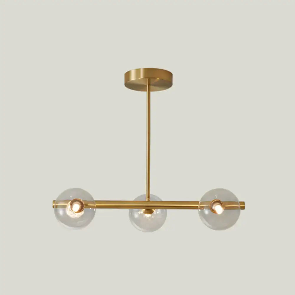 Modern brass 5-light pendant light with spherical glass shade dining room