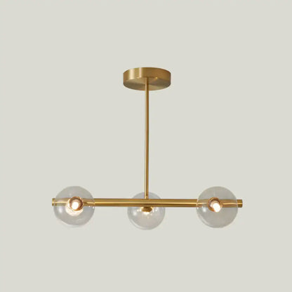 Modern brass 5-light pendant light with spherical glass shade dining room
