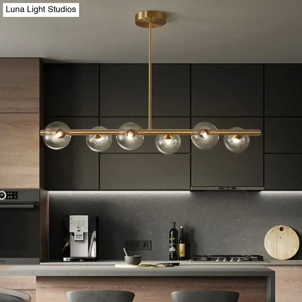 Modern brass 5-light pendant light with spherical glass shade dining room