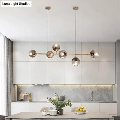 Modern brass 6-bulb island lamp with glass shade for dining rooms