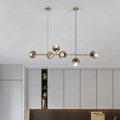 Modern brass 6-bulb island lamp with glass shade for dining rooms
