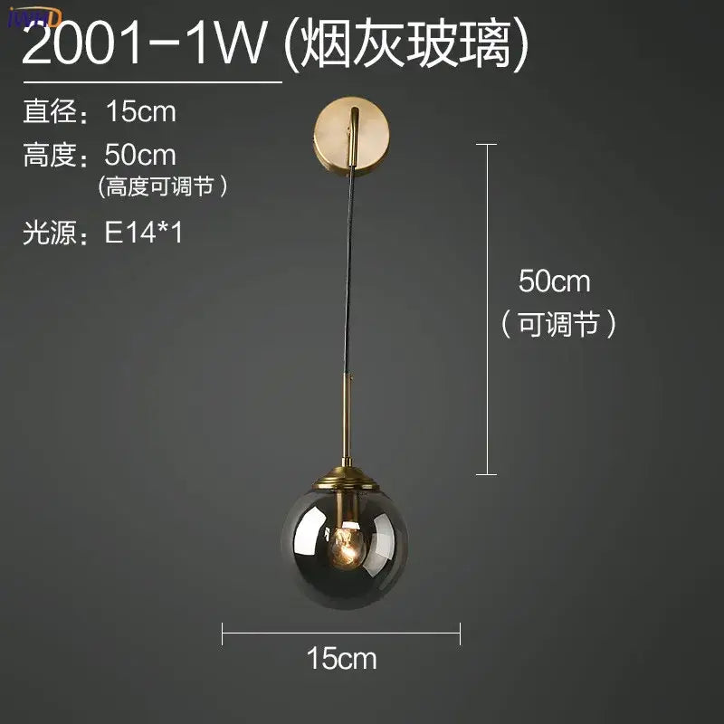 Modern brass and amber glass ball wall lamp for bedroom
