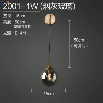 Modern brass and amber glass ball wall lamp for bedroom