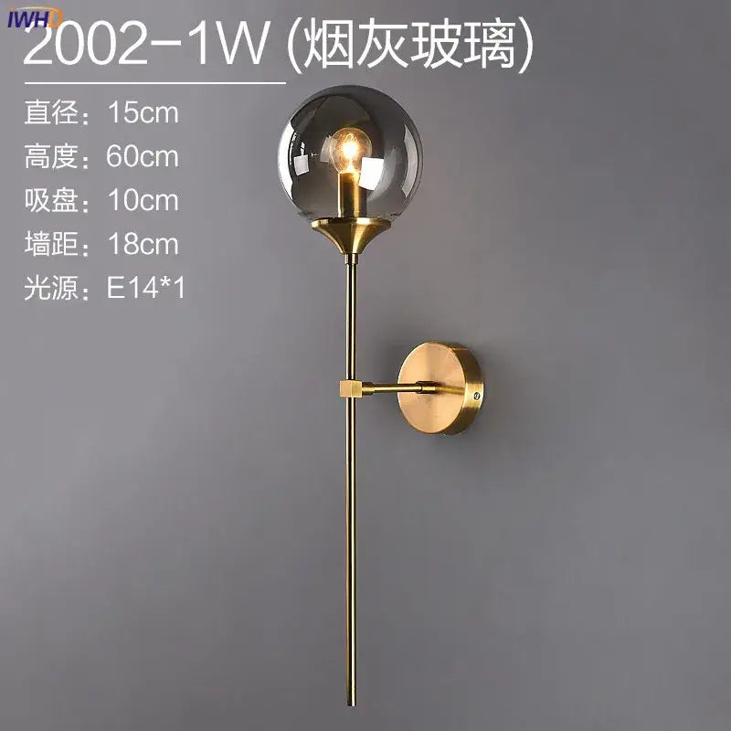 Modern brass and amber glass ball wall lamp for bedroom