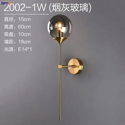 Modern brass and amber glass ball wall lamp for bedroom