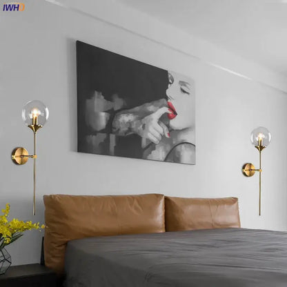 Modern brass and amber glass ball wall lamp for bedroom