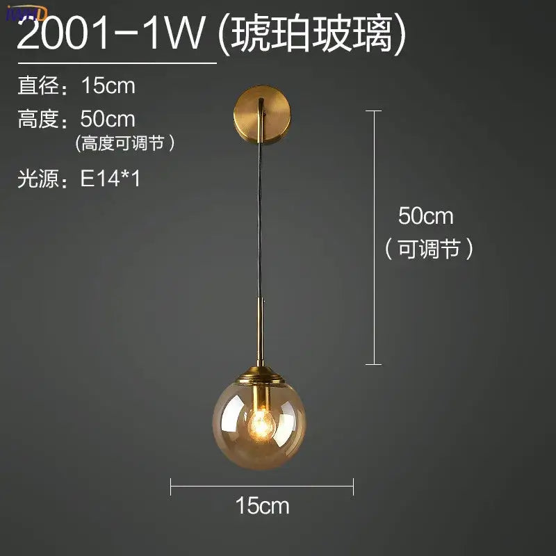 Modern brass and amber glass ball wall lamp for bedroom