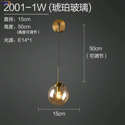 Modern brass and amber glass ball wall lamp for bedroom