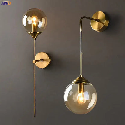 Modern brass and amber glass ball wall lamp for bedroom