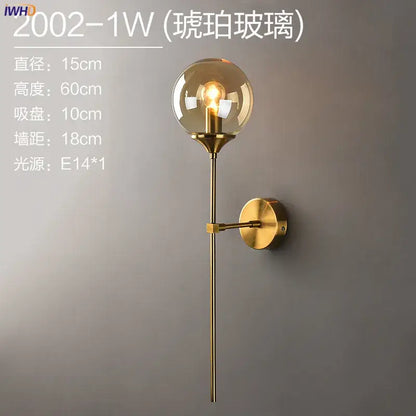 Modern brass and amber glass ball wall lamp for bedroom