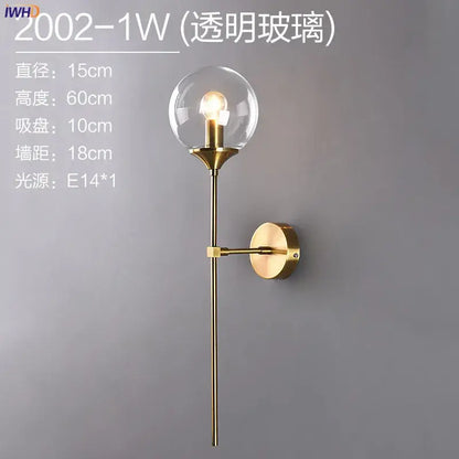 Modern brass and amber glass ball wall lamp for bedroom