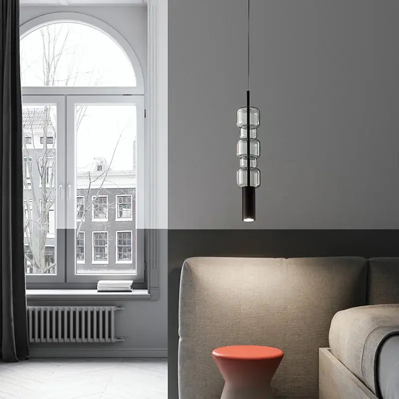 Modern brass and black cylindrical glass pendant light for kitchens