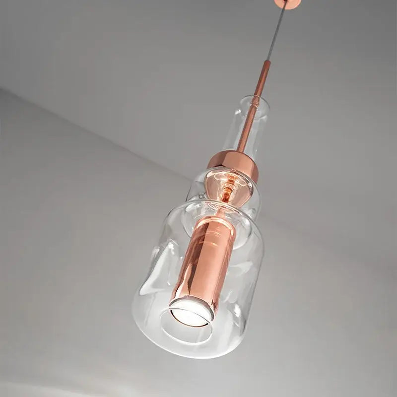 Modern brass and black cylindrical glass pendant light for kitchens