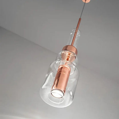 Modern brass and black cylindrical glass pendant light for kitchens