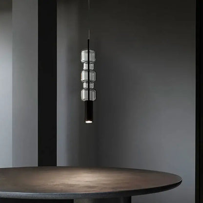 Modern brass and black cylindrical glass pendant light for kitchens
