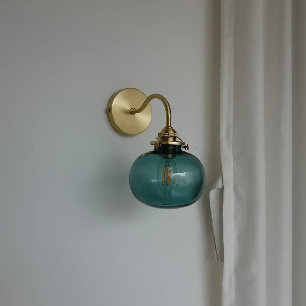 Modern brass and blue glass ball wall sconce with pull chain bedroom