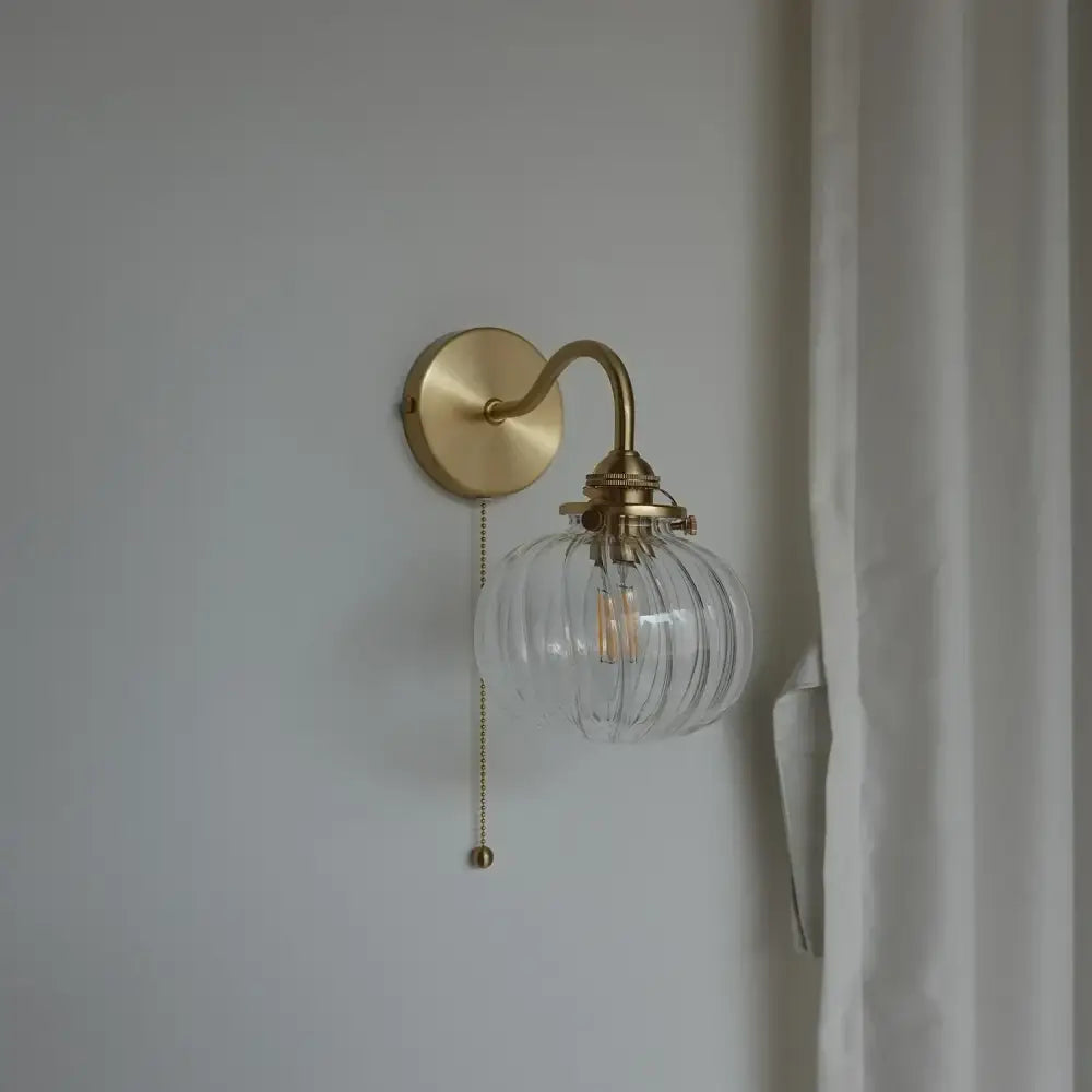 Modern brass and blue glass ball wall sconce with pull chain bedroom