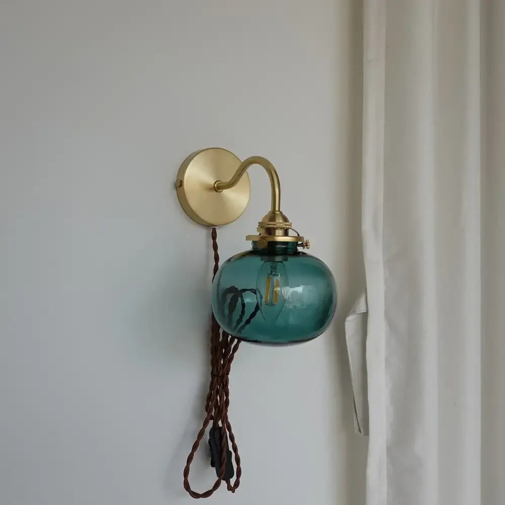 Modern brass and blue glass ball wall sconce with pull chain bedroom