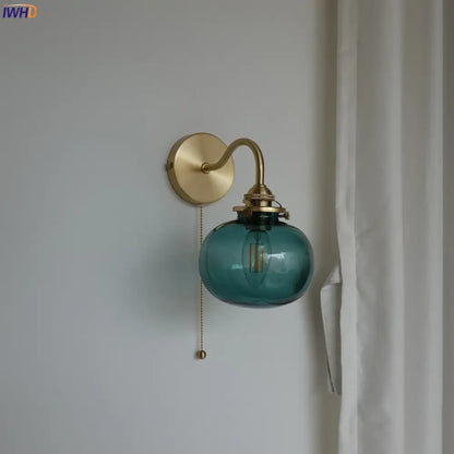 Modern brass and blue glass ball wall sconce with pull chain bedroom