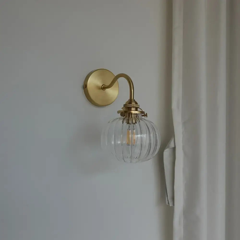 Modern brass and blue glass ball wall sconce with pull chain bedroom