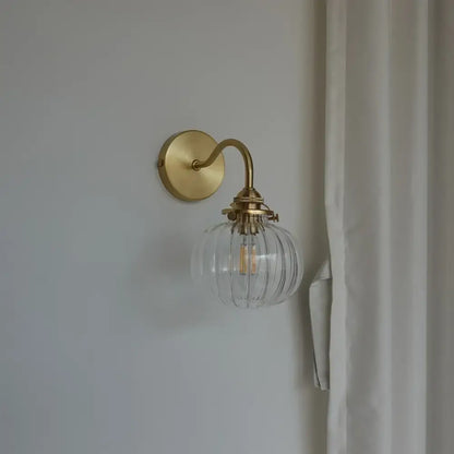 Modern brass and blue glass ball wall sconce with pull chain bedroom