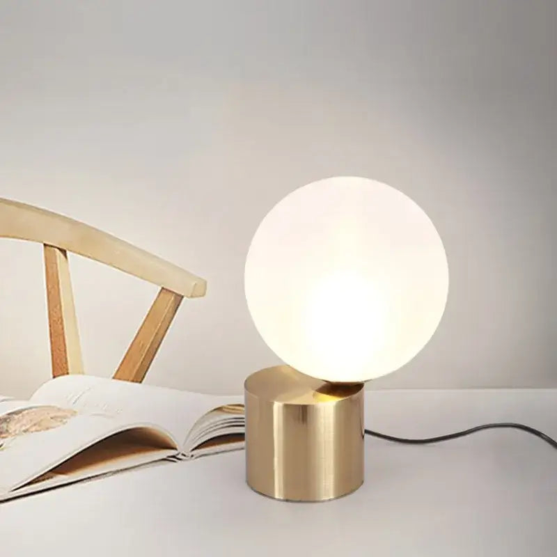 Modern brass and glass circular table lamp for bedroom