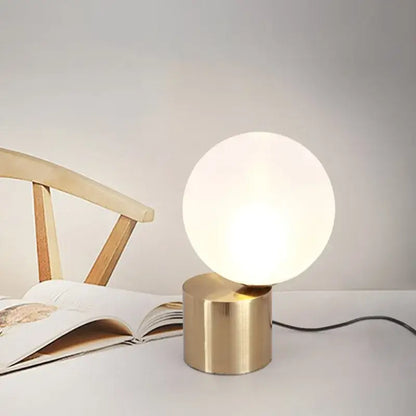 Modern brass and glass circular table lamp for bedroom