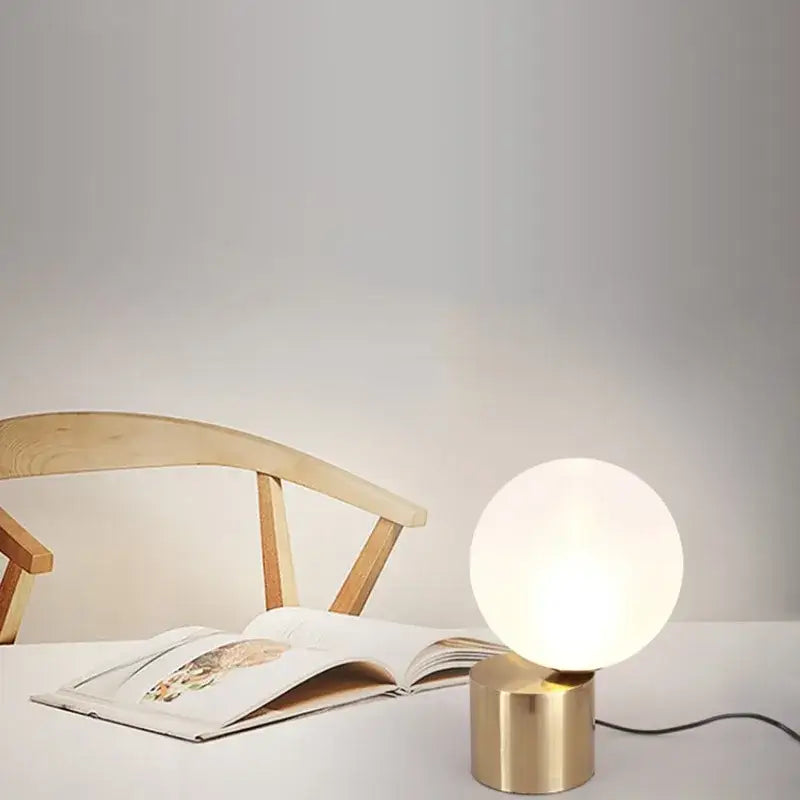Modern brass and glass circular table lamp for bedroom