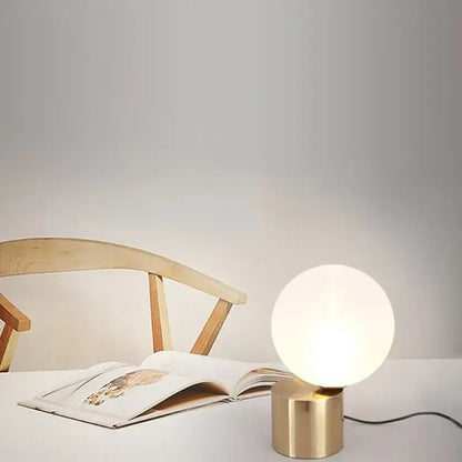Modern brass and glass circular table lamp for bedroom