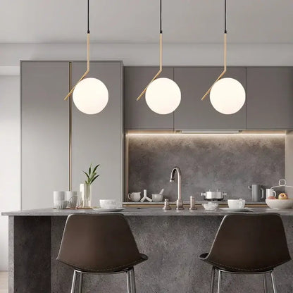 Modern brass and frosted glass ball pendant light dining room fixture