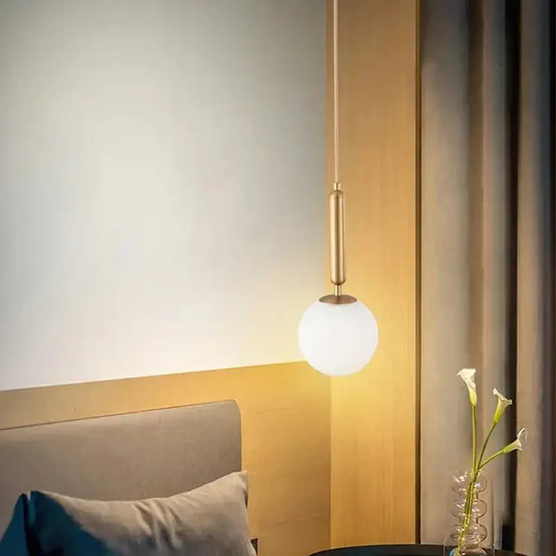 Modern brass and frosted glass ball pendant light for dining room