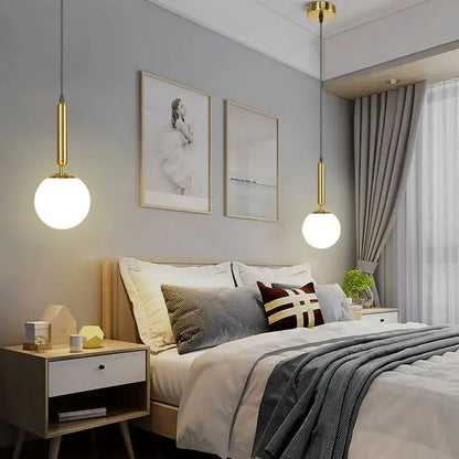Modern brass and frosted glass ball pendant light for dining room