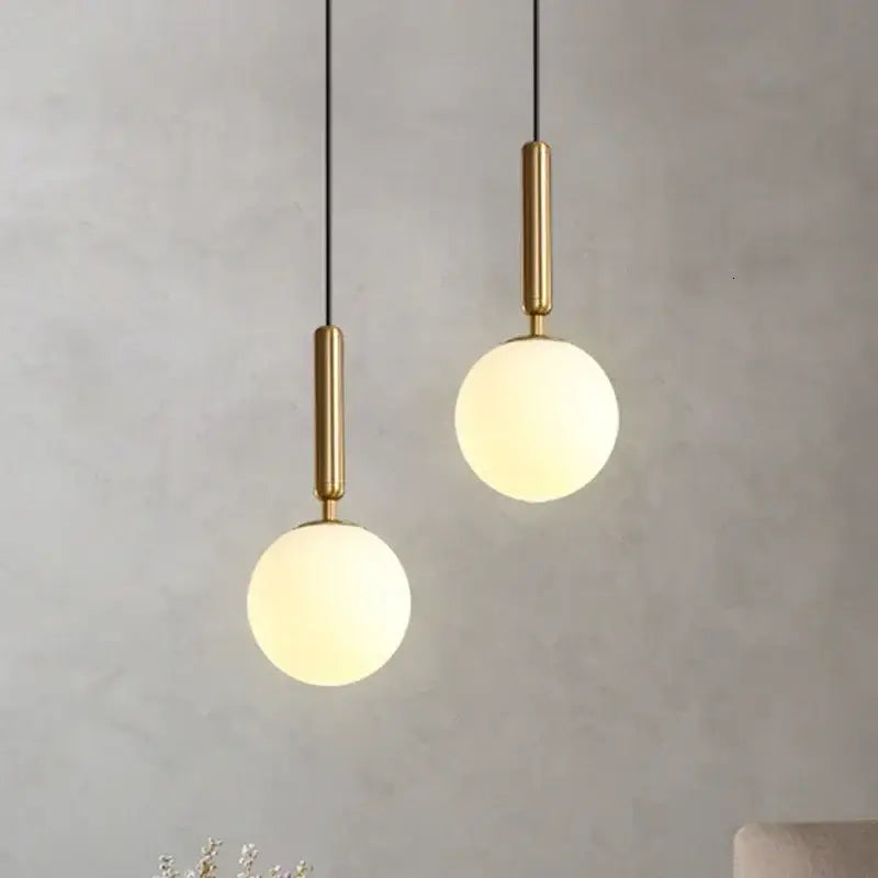 Modern brass and frosted glass ball pendant light for dining room