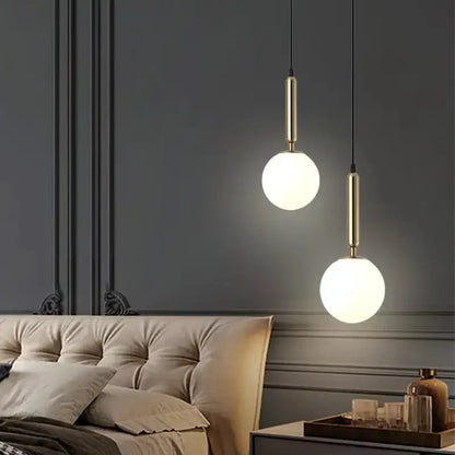 Modern brass and frosted glass ball pendant light for dining room