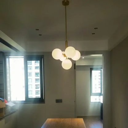 Modern brass and frosted glass chandelier for living room dining decor