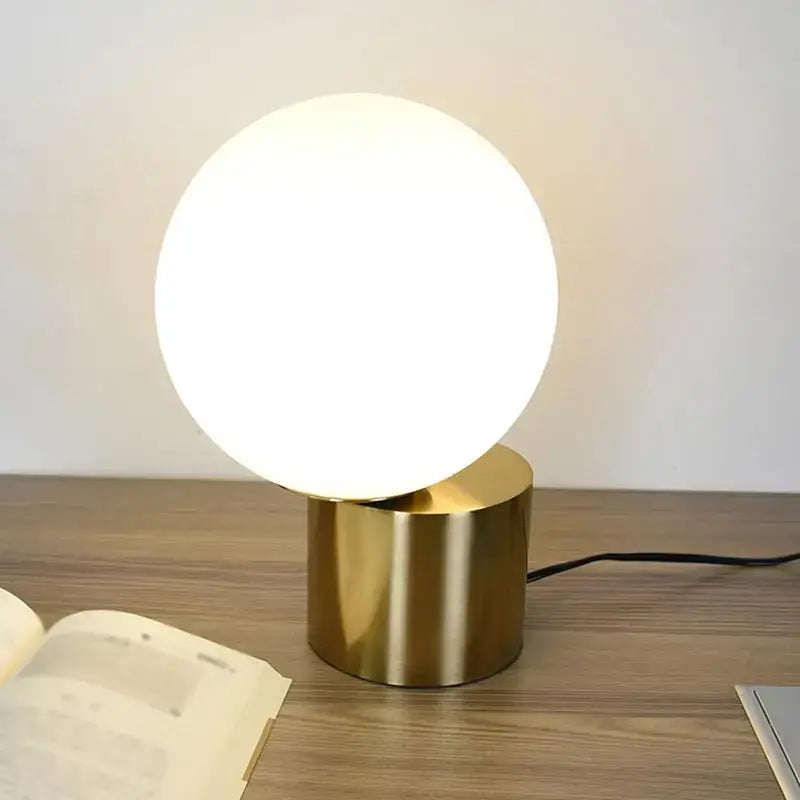 Modern brass and glass desk lamp for bedroom with spherical shade