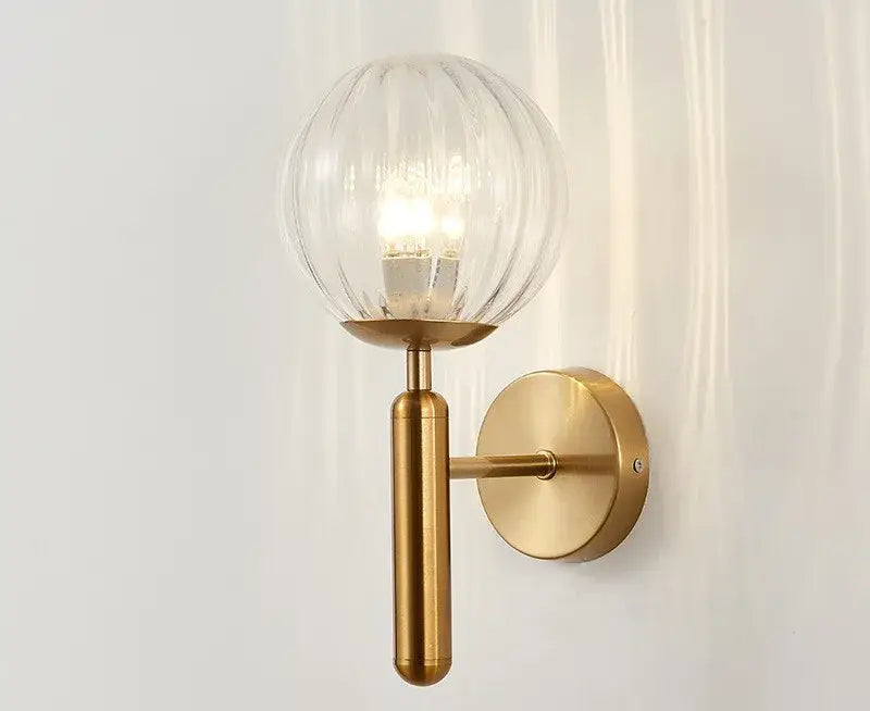 Modern brass and pink glass wall sconce for bedroom
