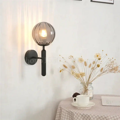 Modern brass and pink glass wall sconce for bedroom