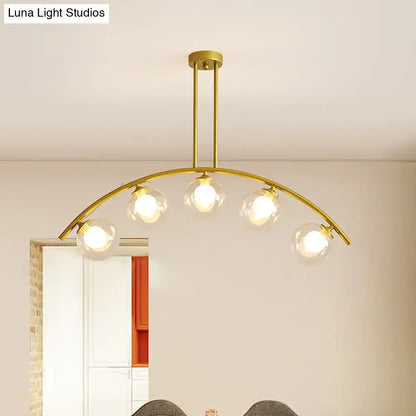 Modern brass arch arm 5-light pendant – dining room glass orb light