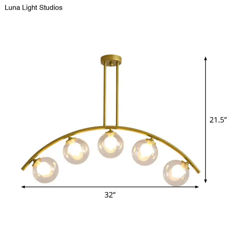 Modern brass arch arm 5-light pendant – dining room glass orb light