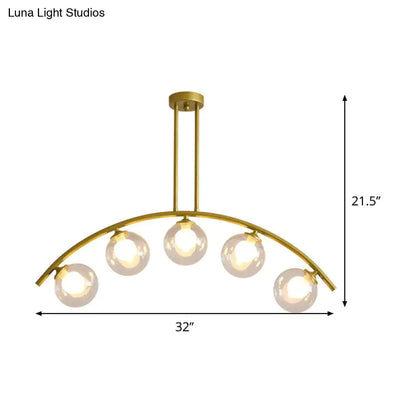 Modern brass arch arm 5-light pendant – dining room glass orb light