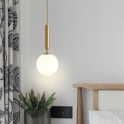 Modern brass & black glass ball pendant light for dining room