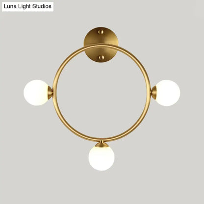Modern brass circular wall light fixture with glass shades bedroom