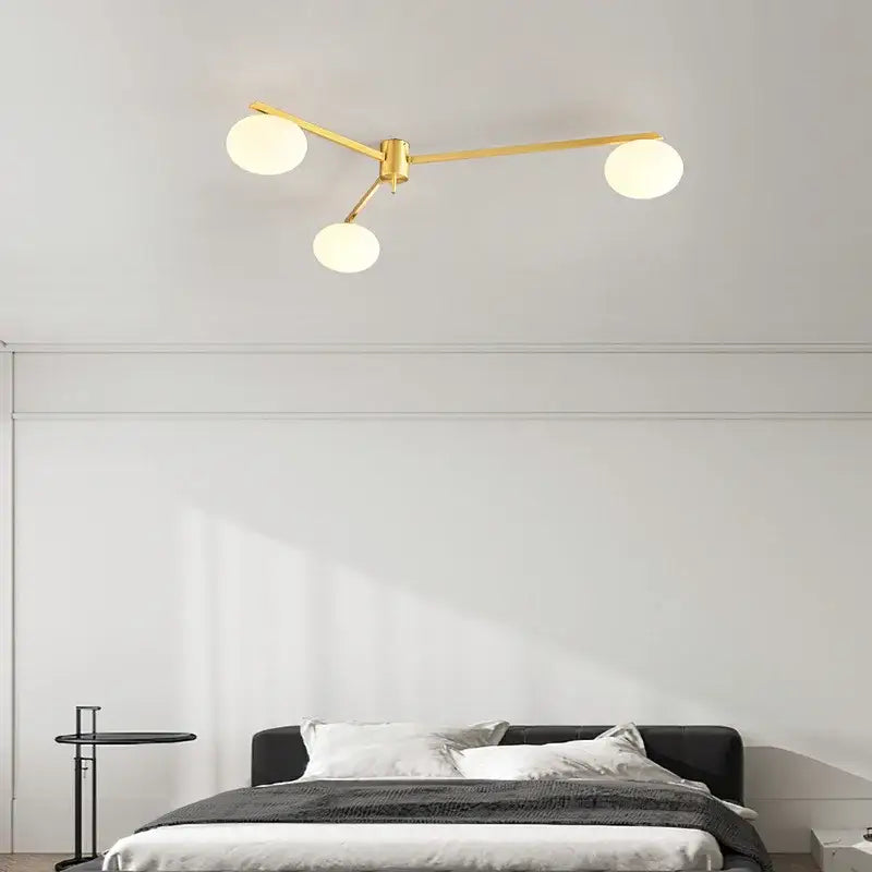 Modern brass glass ceiling lamp with frosted globes for living room