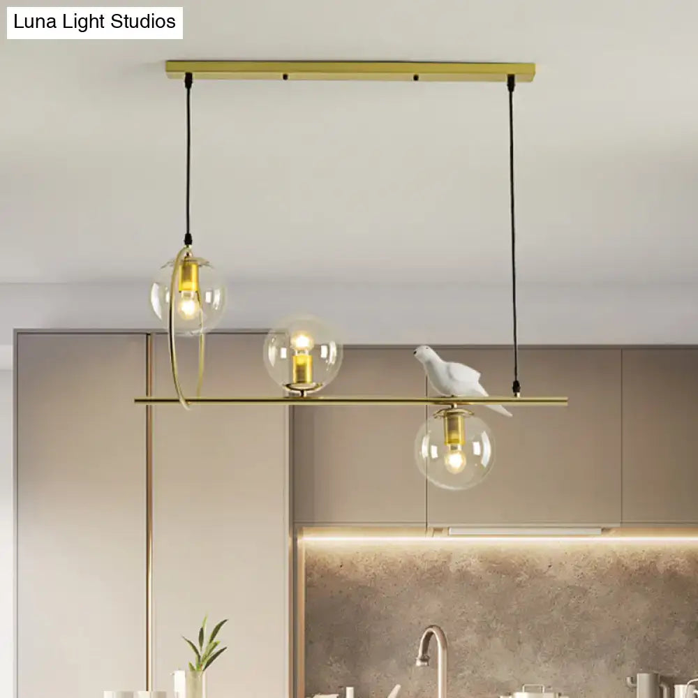 Modern brass global island lamp with white bird dining room light