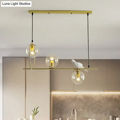 Modern brass global island lamp with white bird dining room light