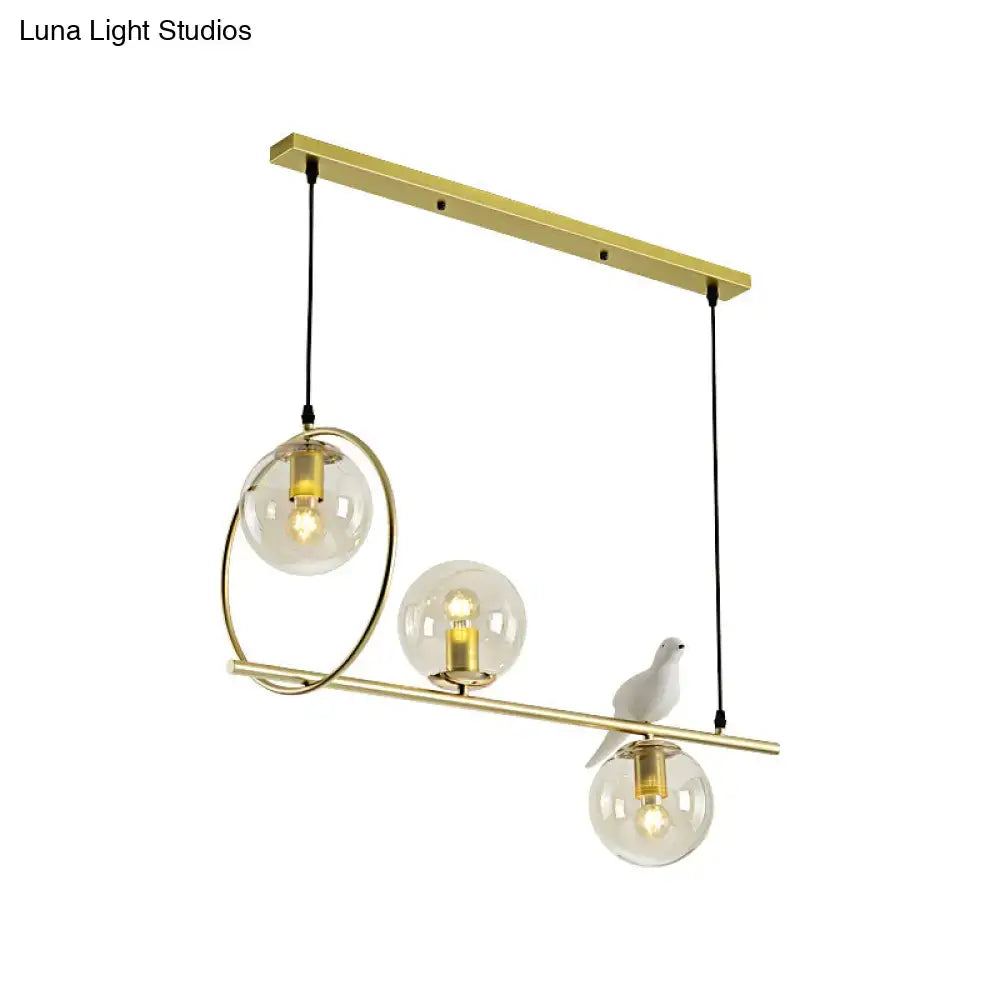 Modern brass global island lamp with white bird dining room light