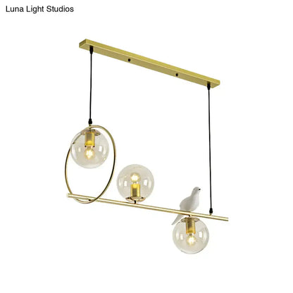 Modern brass global island lamp with white bird dining room light