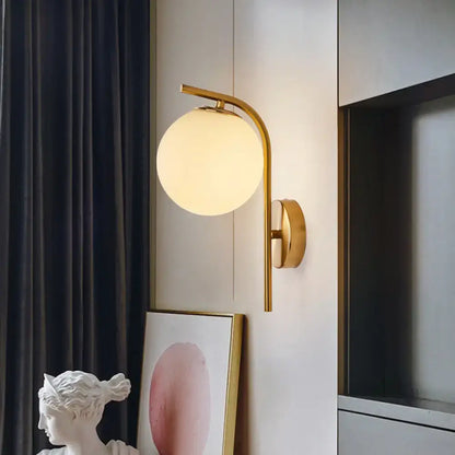 Modern brass globe bedside lamp with frosted glass for bedroom