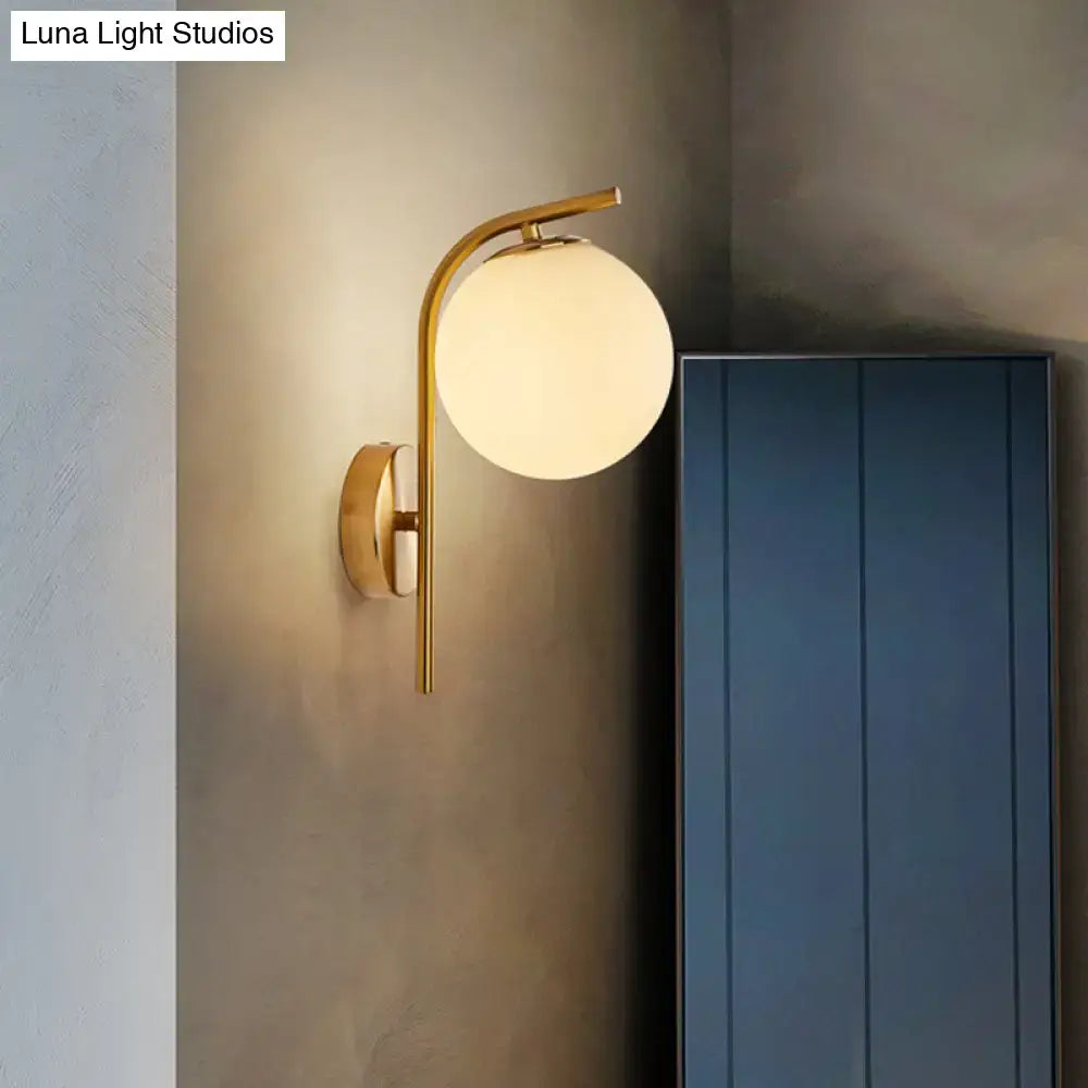 Modern brass globe bedside lamp with frosted glass for bedroom
